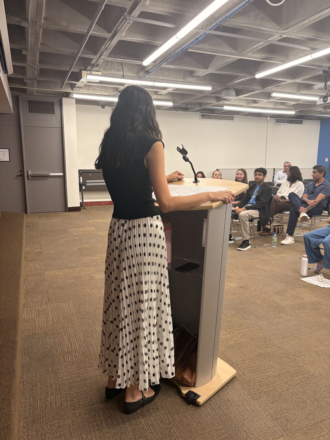 Kaya Bhandari speaking at a podium