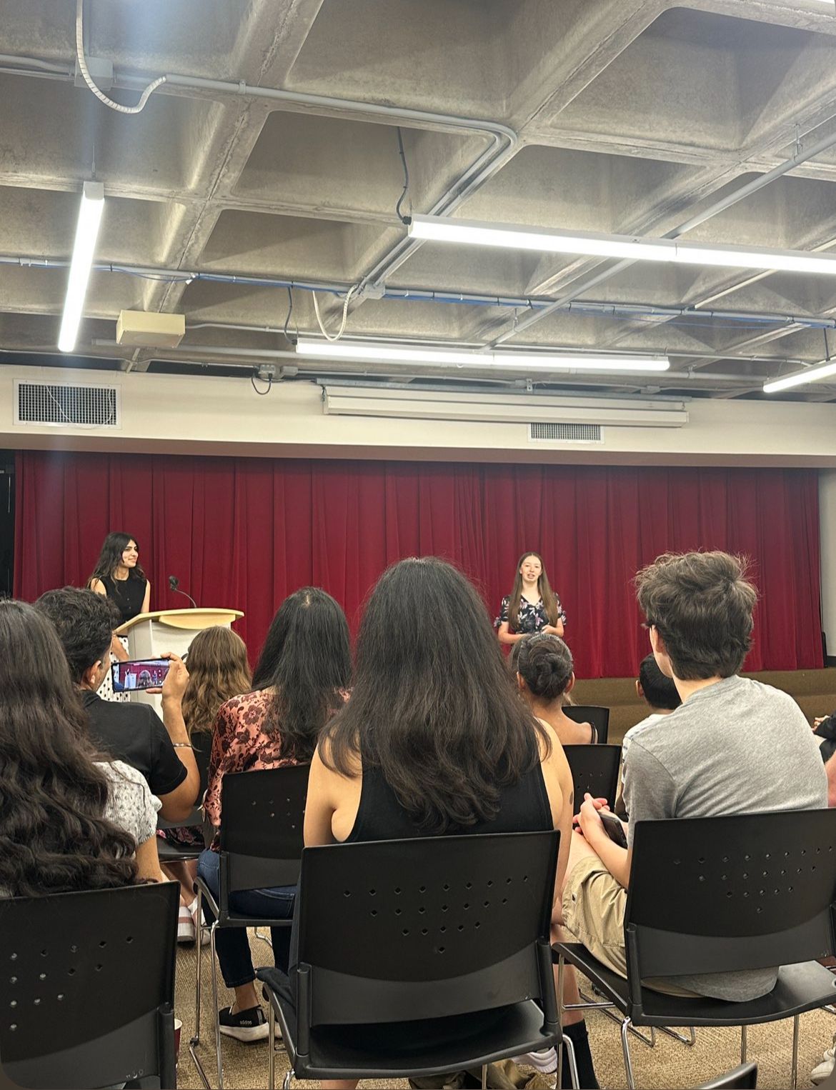 Two students presenting on stage at the showcase