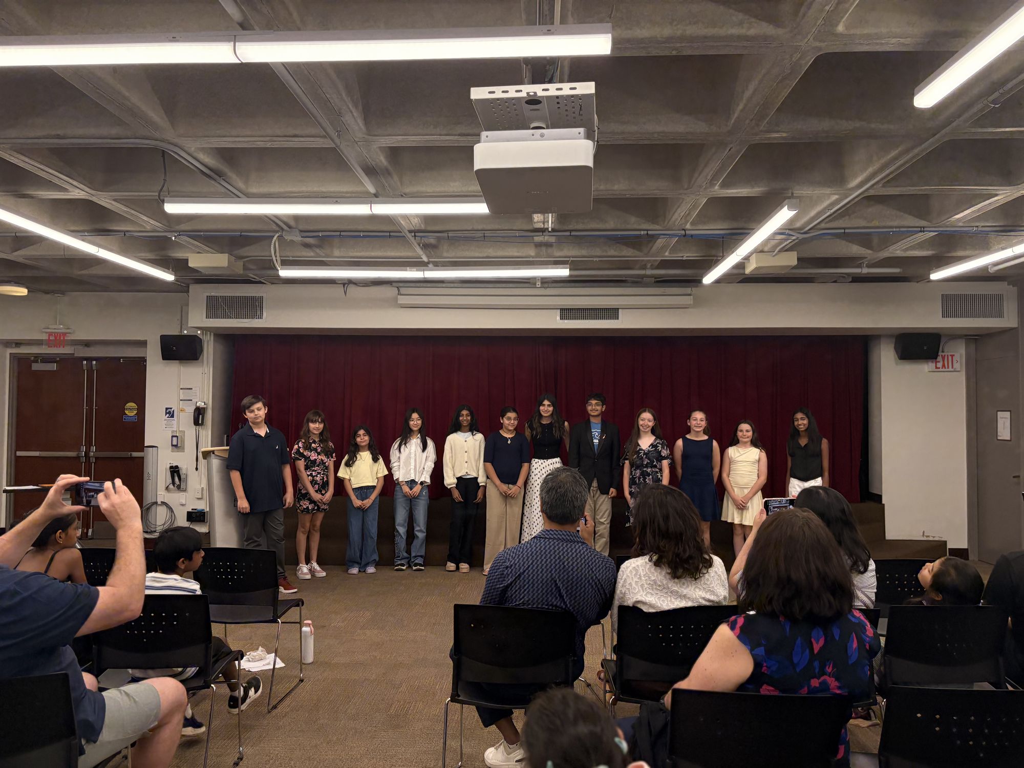 Students on stage at the final showcase of Kaya Bhandari's summer public speaking program